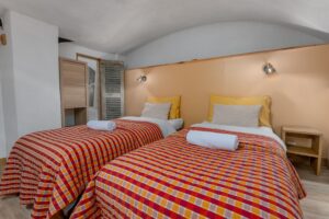The second bedroom offers two single beds and ample storage