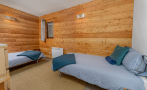 A second bedroom with two single beds and room to move